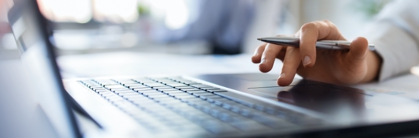 woman scrolling on mousepad on laptop